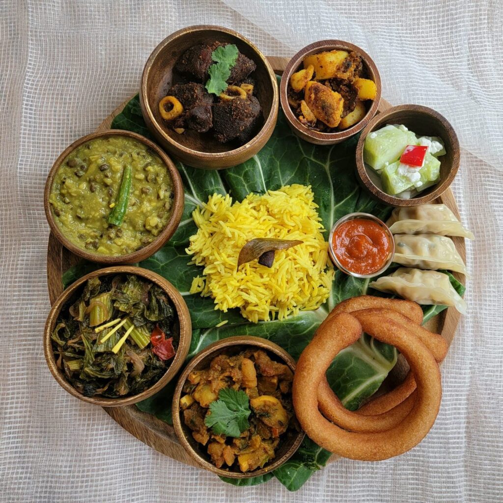 A Sikkimese woman cooking in a traditional kitchen, representing Sikkim's food culture and the preparation of Sikkim's traditional food and specialties.