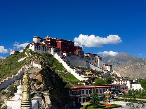 “Local Tibetan monastery surrounded by mountains, capturing the serene cultural atmosphere experienced on a Tibet tour.”